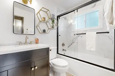 a bathroom with a shower and a toilet and a sink at Groovy Days Chalet in Arnold