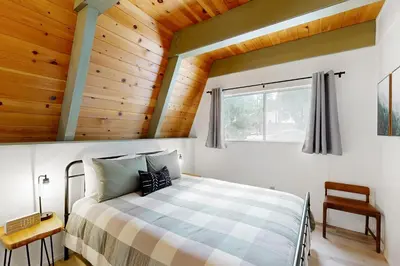 a bedroom with a bed and a wooden ceiling at Groovy Days Chalet in Arnold