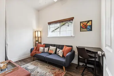 a living room with a couch and a window at ¤ Old Folsom La Boheme Artist Retreat + Jacuzzi ¤ in Folsom