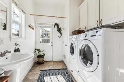 a white laundry room with a sink and a washing machine at ¤ Old Folsom La Boheme Artist Retreat + Jacuzzi ¤ in Folsom