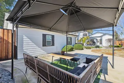 a patio with a table and an umbrella at ¤ Old Folsom La Boheme Artist Retreat + Jacuzzi ¤ in Folsom