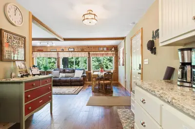 a kitchen and living room with a couch and a table at Sugar Pine cabin in the woods King bed Fire pit in Oakhurst