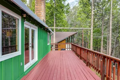 a wooden porch of a house with a red deck at Cozy Mi-Wuk Village Cabin 18 Mi to Dodge Ridge! in Mi-Wuk Village