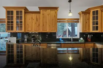 a kitchen with wooden cabinets and a sink at Family Friendly 3BD-Next to Beach & Ski Resort in Kings Beach