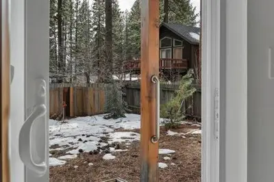 a door open to a yard with snow on the ground at Family Friendly 3BD-Next to Beach & Ski Resort in Kings Beach