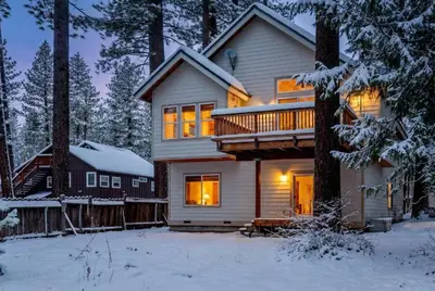 a house in the woods in the snow at Family Friendly 3BD-Next to Beach & Ski Resort in Kings Beach