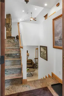 a staircase in a living room with a ceiling fan at Family Friendly 3BD-Next to Beach & Ski Resort in Kings Beach