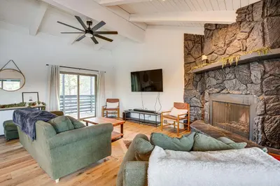 a living room with two couches and a stone fireplace at 6 Mi to Slopes Mtn-View Retreat in Lake Tahoe in South Lake Tahoe