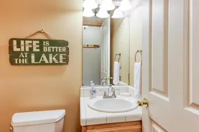 a bathroom with a sink and a toilet and a mirror at Gentian Family Retreat in South Lake Tahoe