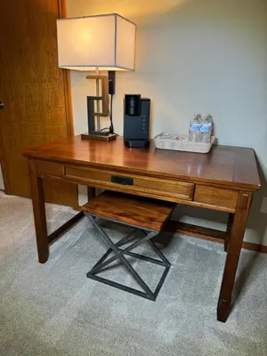 a wooden desk with a lamp on top of it at Meadow Landing in Three Rivers