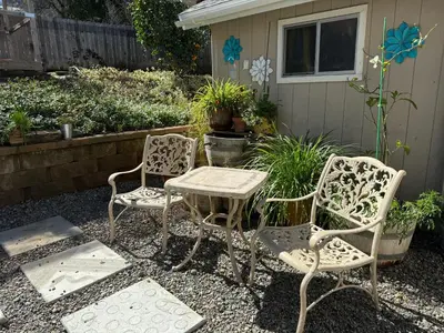 two chairs and a table and a table and chairs at Meadow Landing in Three Rivers