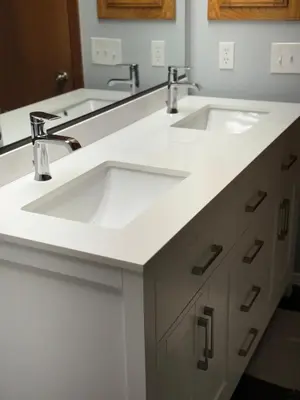 a bathroom with two sinks and two faucets at Meadow Landing in Three Rivers