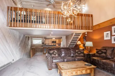 a living room with a couch and a table at Snowcreek #309 2 Plus Loft, 2 Bathroom Condo Sleeps 8 People with Amazing Mountain Views in Mammoth Lakes