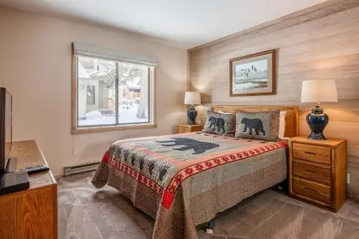 a bedroom with a bed and a window at Snowcreek #309 2 Plus Loft, 2 Bathroom Condo Sleeps 8 People with Amazing Mountain Views in Mammoth Lakes