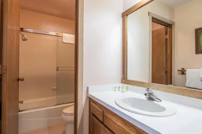 a bathroom with a sink and a toilet and a mirror at Snowcreek #309 2 Plus Loft, 2 Bathroom Condo Sleeps 8 People with Amazing Mountain Views in Mammoth Lakes