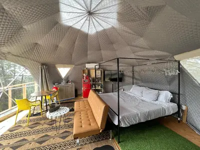 a bedroom with a canopy bed in a tent at Mountain view Dome- 10 Minutes to National Park in Dunlap