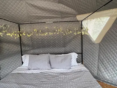 a bed in a tent with a window and lights at Mountain view Dome- 10 Minutes to National Park in Dunlap