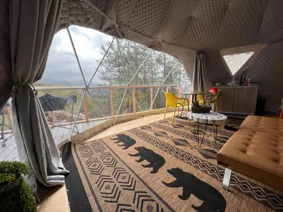 a room with a view of a balcony with a table and chairs at Mountain view Dome- 10 Minutes to National Park in Dunlap