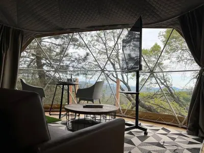 a room with a table and chairs in a tent at Glamping Dome 1 - 10 minutes from Kings Canyon in Dunlap