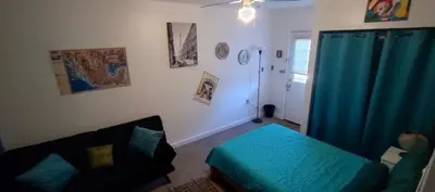 a bedroom with a bed and a couch in a room at Private Guest Cozy Room w/Full Bathroom in Lake Isabella