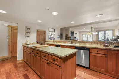a large kitchen with wooden cabinets and granite counter tops at Lavishness at Elevation – Timber Ridge 3 Bedroom condo in Kirkwood