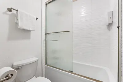 a white bathroom with a shower and a toilet at Luxury at Altitude – Base Camp 2 Bedroom condo in Kirkwood