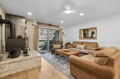 a living room with a couch and a fireplace at Luxury at Altitude – Base Camp 2 Bedroom condo in Kirkwood