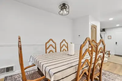 a bedroom with a bed and chairs in a room at Luxury at Altitude – Base Camp 2 Bedroom condo in Kirkwood