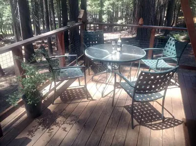 a patio with a table and chairs on a deck at Sweet Retreat: Theater, Pool/Ping-Pong, Quiet! in Camp Connell