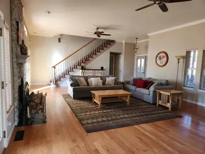 a living room with a couch and a table at Master Suite Fraser Family Vineyard Stay in Amador in Plymouth