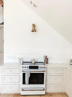 a kitchen with white cabinets and a stove at Homestead Barn Loft in Sonora