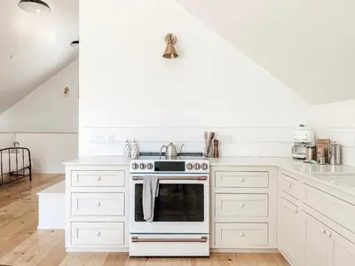 a kitchen with white cabinets and an oven at Homestead Barn Loft in Sonora