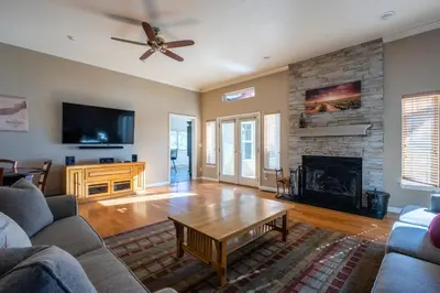 a living room with a couch and a fireplace at Balcony Suite Fraser Family Vineyard Stay in Amador in Plymouth