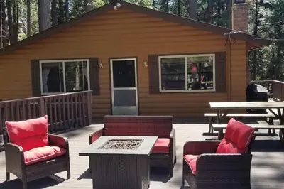 a deck with chairs and a table and a cabin at Mountain Life On Deck in Arnold