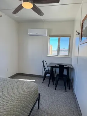 a bedroom with a bed and a table and chairs at Eastern Sierra Motor Lodge in Independence