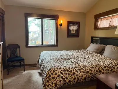 a bedroom with a bed and a window at Cabin in the Woods in Tahoe Vista