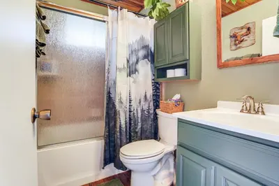 a bathroom with a toilet and a sink at Enchanted Woodland Cabin Near Yosemite with Fire Pit in Groveland