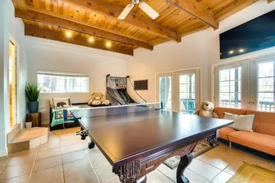 a large living room with a ping pong table at Enchanted Woodland Cabin Near Yosemite with Fire Pit in Groveland