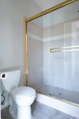 a bathroom with a toilet and a glass shower at Balcony Suite 2 Fraser Family Vineyard Stay in Amador in Plymouth