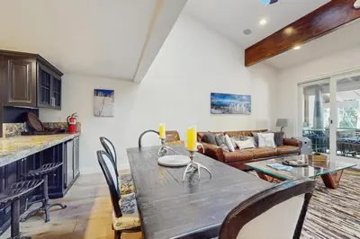 a kitchen and living room with a wooden table and chairs at High Sierra Haven in Incline Village