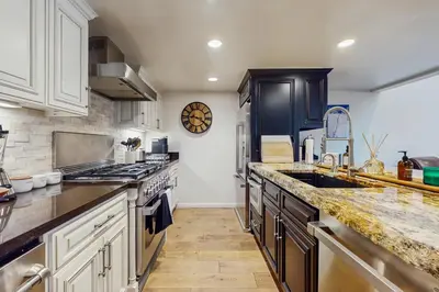 a kitchen with white cabinets and a large sink at High Sierra Haven in Incline Village