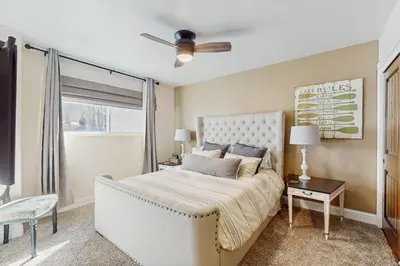 a bedroom with a large bed with a ceiling fan at High Sierra Haven in Incline Village