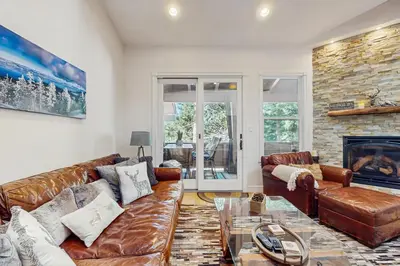 a living room with a leather couch and a fireplace at High Sierra Haven in Incline Village
