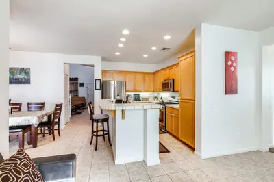 a kitchen and dining room with a table and chairs at Spacious Turlock Home about 1 Mi to University! in Turlock