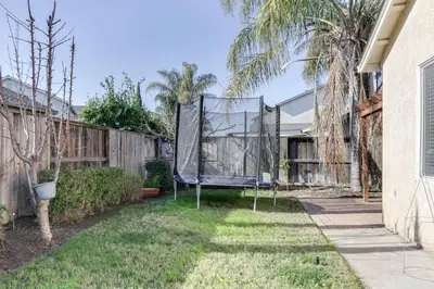 a backyard with a basketball hoop in the yard at Spacious Turlock Home about 1 Mi to University! in Turlock