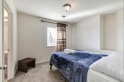a bedroom with a bed and a window at Spacious Turlock Home about 1 Mi to University! in Turlock
