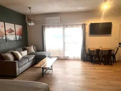 a living room with a couch and a table at Wofford Village Studios in Wofford Heights