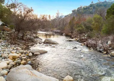 a river with rocks and trees and a mountain at 4 Miles to Sequoia NTL Park in Three Rivers