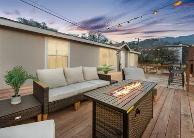 a patio with a couch and a fire pit at 4 Mil to Sequoia NTL Park Private River Access in Three Rivers