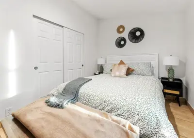 a bedroom with a bed and a clock on the wall at 4 Mil to Sequoia NTL Park Private River Access in Three Rivers